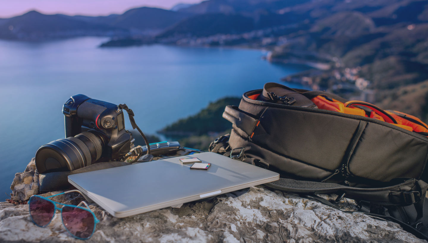 computer and camera overlooking a lake