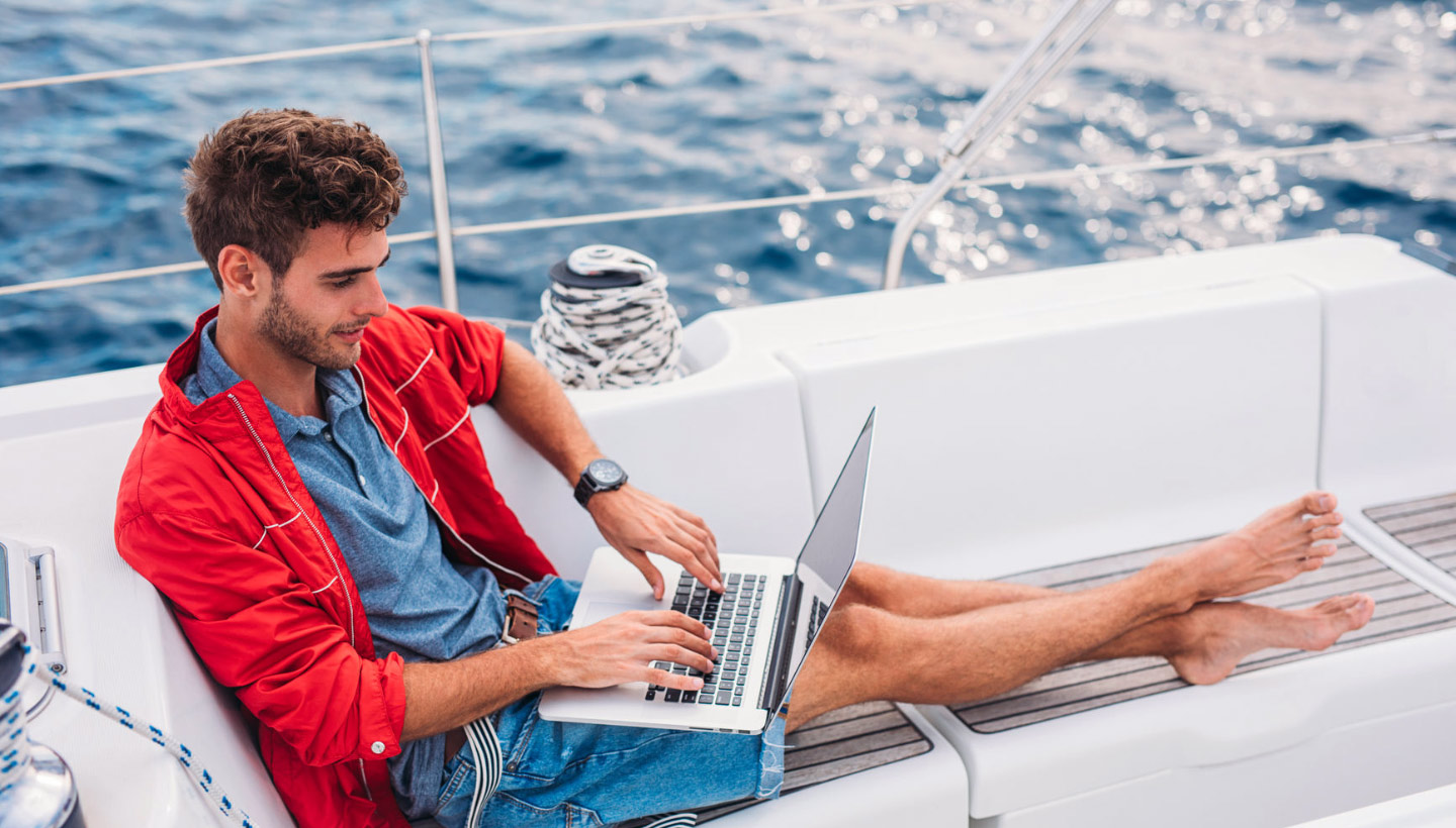 working on a computer on a boat
