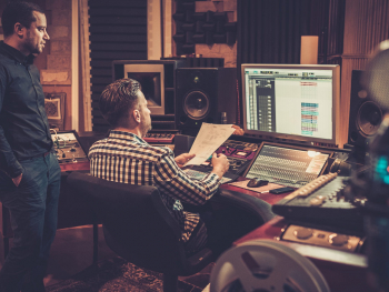 looking at mixing board in a music studio