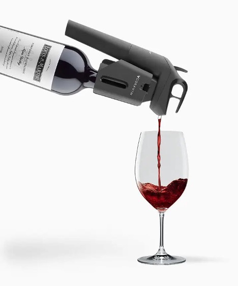 An image showing a Coravin attached to a wine bottle pouring wine into a glass. 